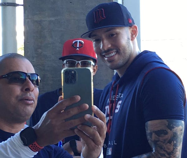 New Twins shortstop Carlos Correa signed and posed for fans after officially signing with the team on Tuesday in Fort Myers, Fla.