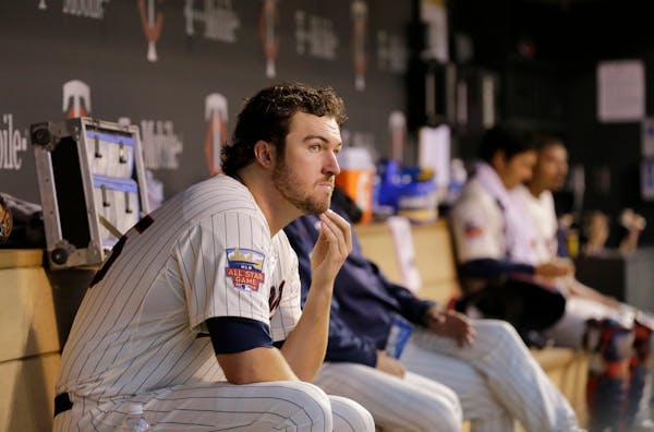 Minnesota Twins pitcher Phil Hughes sits in the dugout during the fourth inning of a baseball game against the Los Angeles Angels in Minneapolis, Satu