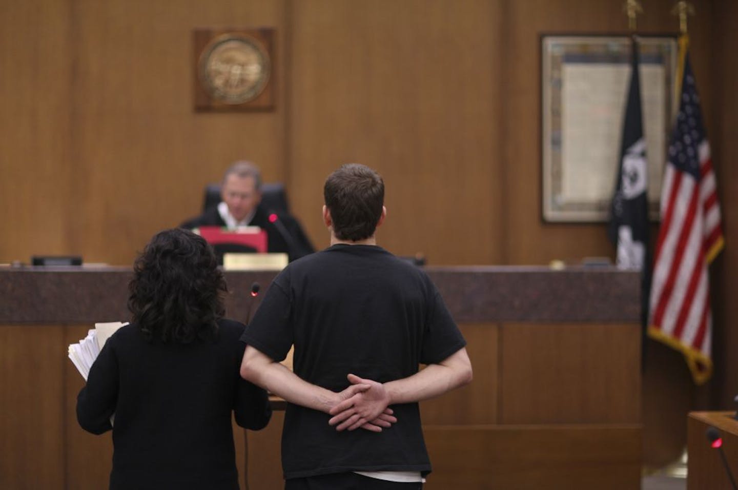 Public defender Chela Guzman-Wiegert stood with her client before Judge Charles Porter in Hennepin County Veterans Court recently.