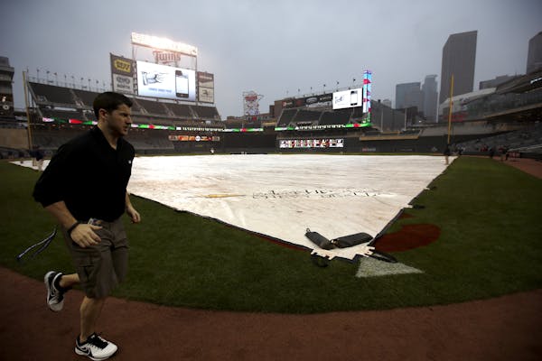 The tarp at Target Field was placed on the infield before the game was postponed on Wednesday night.