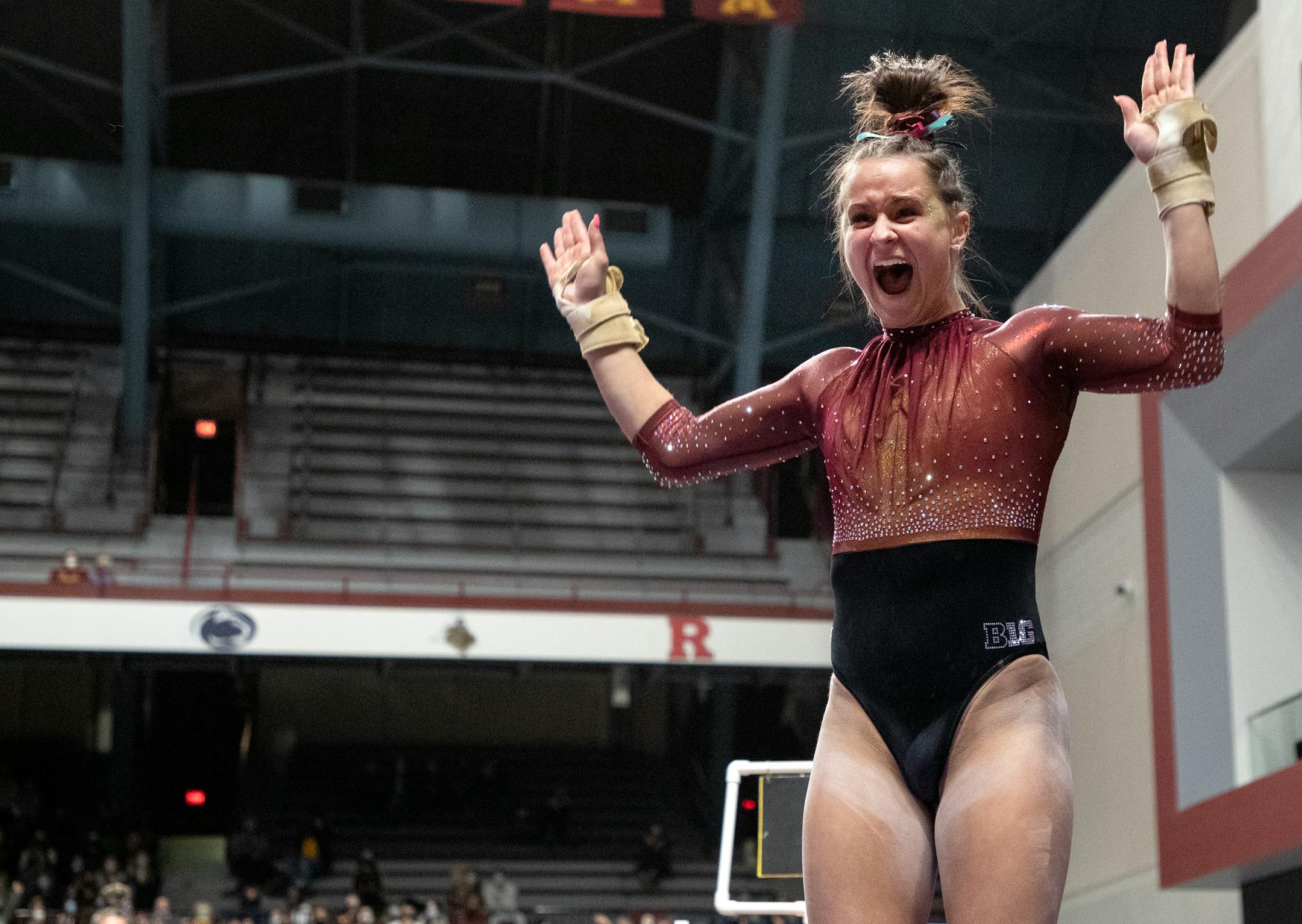 Maddie Quarles of Minnesota reacts after competing in the vault.