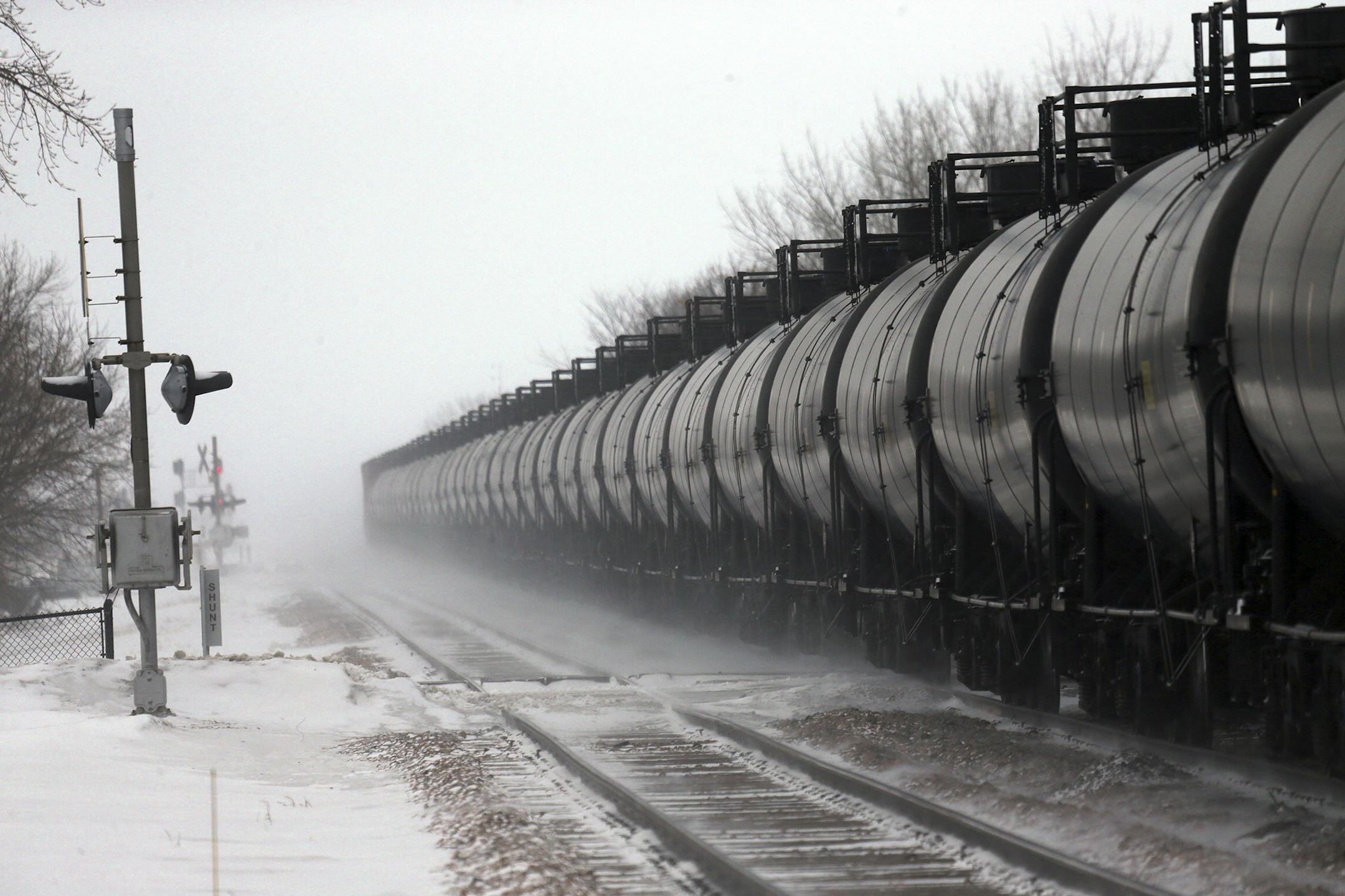 Cars on an oil train roll through Casselton, N.D., Jan. 16, 2014. A fiery rail accident last month in Casselton, N.D., which prompted residents to evacuate the town, has shattered people's confidence in the crude-oil convoys that rumble past seven times a day. (Jim Wilson/The New York Times) ORG XMIT: MIN2014021414074052