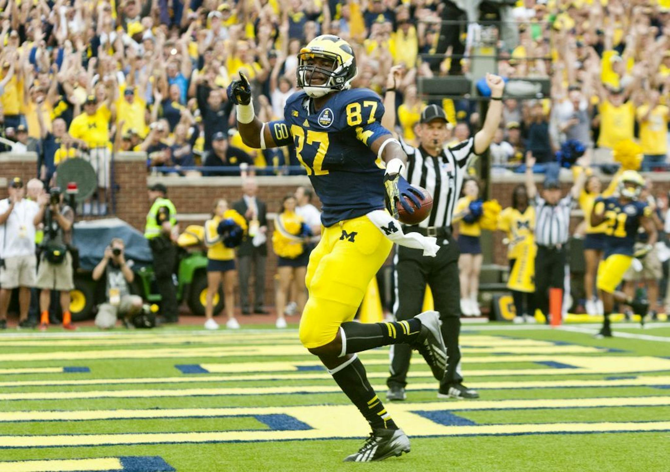 Michigan tight end Devin Funchess (87) scores a touchdown in the second quarter of an NCAA college football game against Minnesota, Saturday, Oct. 5, 2013, in Ann Arbor, Mich.