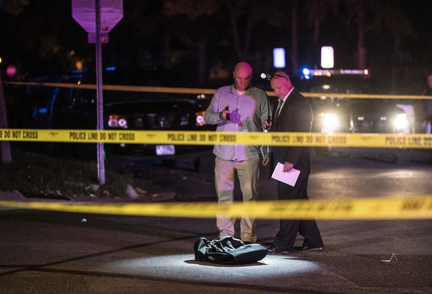 Investigators walked through the scene of a homicide in St. Paul, Minn., on the evening of Wednesday, September 18, 2019.