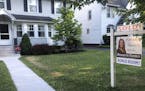 FILE - In this July 4, 2020 photo, a sold sign hangs in front of a house in Brighton, N.Y. More Americans signed contracts to buy homes in July, a sig
