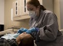 Dr. Amber Walker put a filling in Maria Garcia's tooth at Hope Dental Clinic on Thursday, February 8, 2018, in St. Paul, Minn. Hope Dental Clinic, a f
