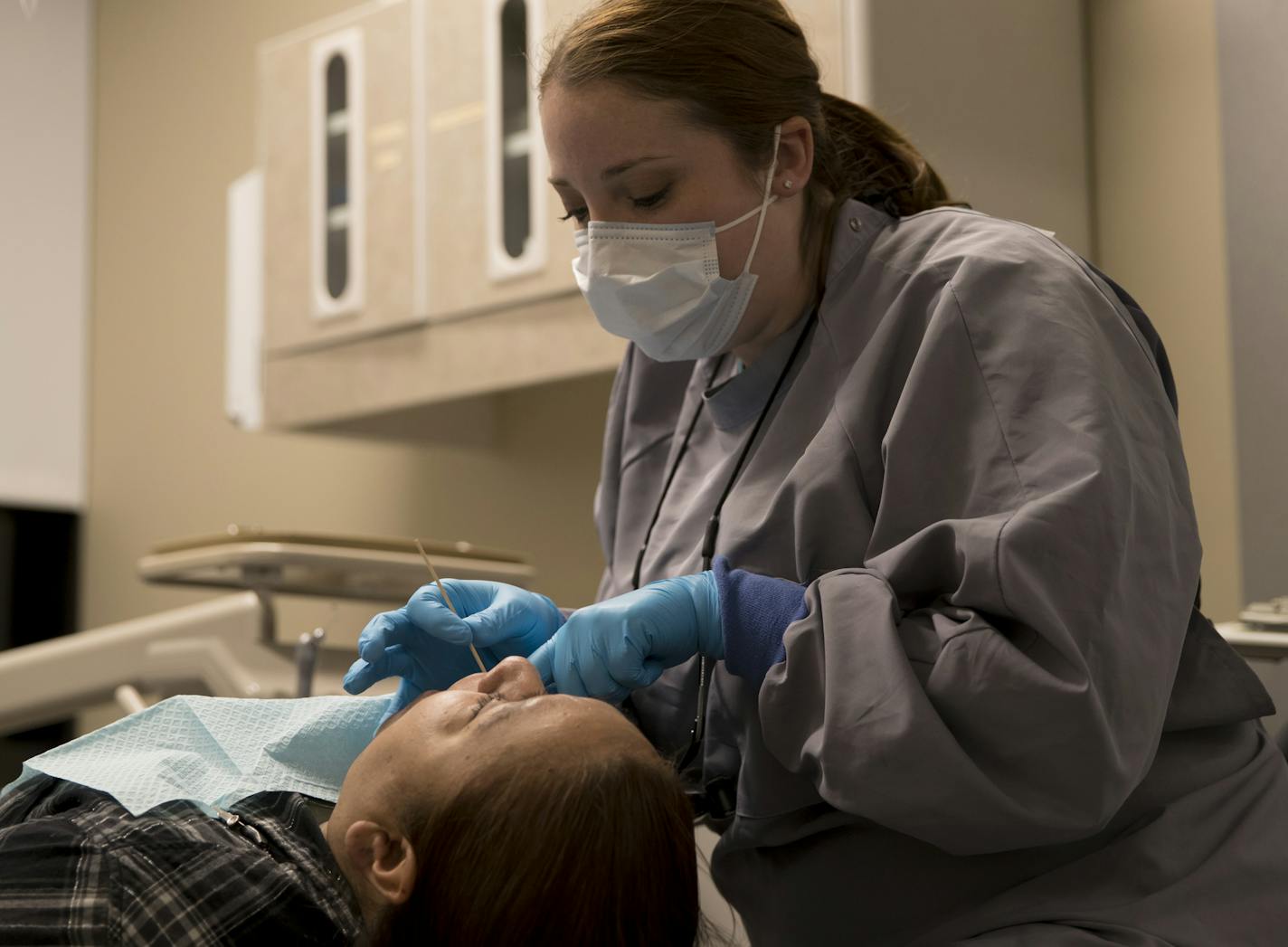 Dr. Amber Walker put a filling in Maria Garcia's tooth at Hope Dental Clinic on Thursday, February 8, 2018, in St. Paul, Minn. Hope Dental Clinic, a free dental clinic, started in early 2017 as an offshoot of a free operation provided to the clients of Union Gospel Mission in St. Paul since 1965. Dozens of volunteer dentists work out of the clinic in the Dayton's Bluff neighborhood on the East Side of St. Paul, serving families and children too poor to pay for even the most basic dental care. ]