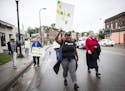 Community members were led along West Broadway Avenue during a peace walk in north Minneapolis by community activist, Shantae Peace, Friday afternoon.