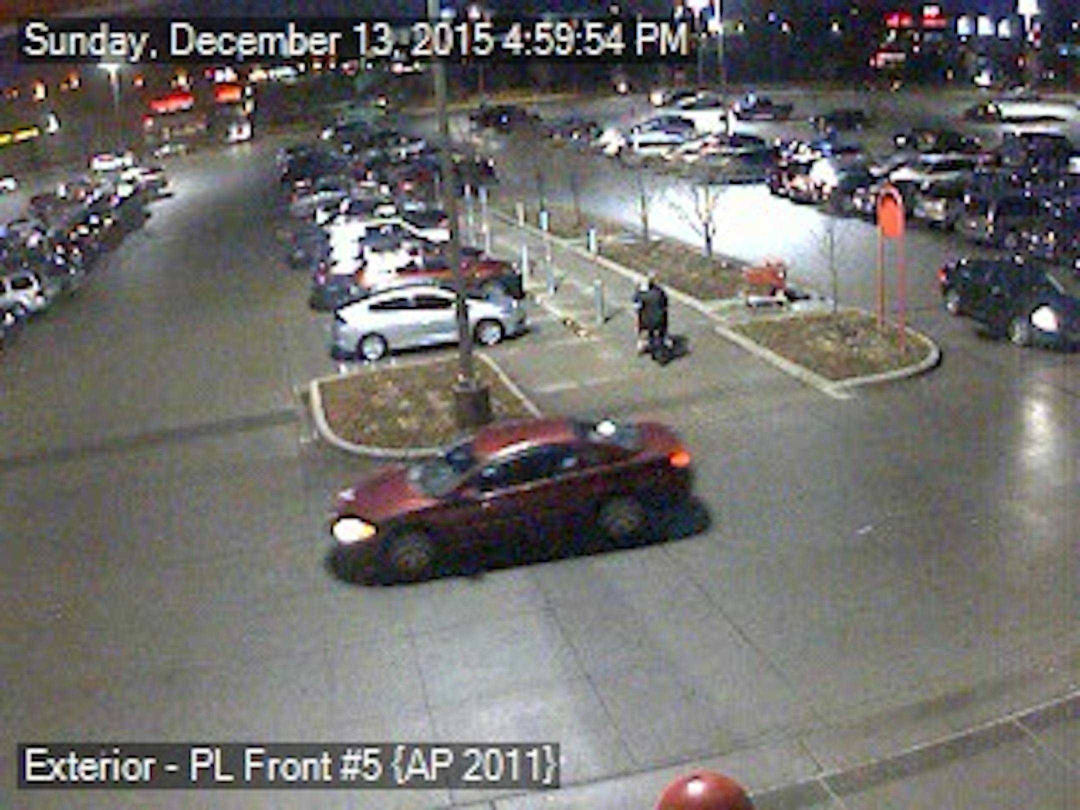 A man and a woman involved in the discharge of a gun in a Fridley Target store were seen leaving in this red or maroon vehicle in the foreground.