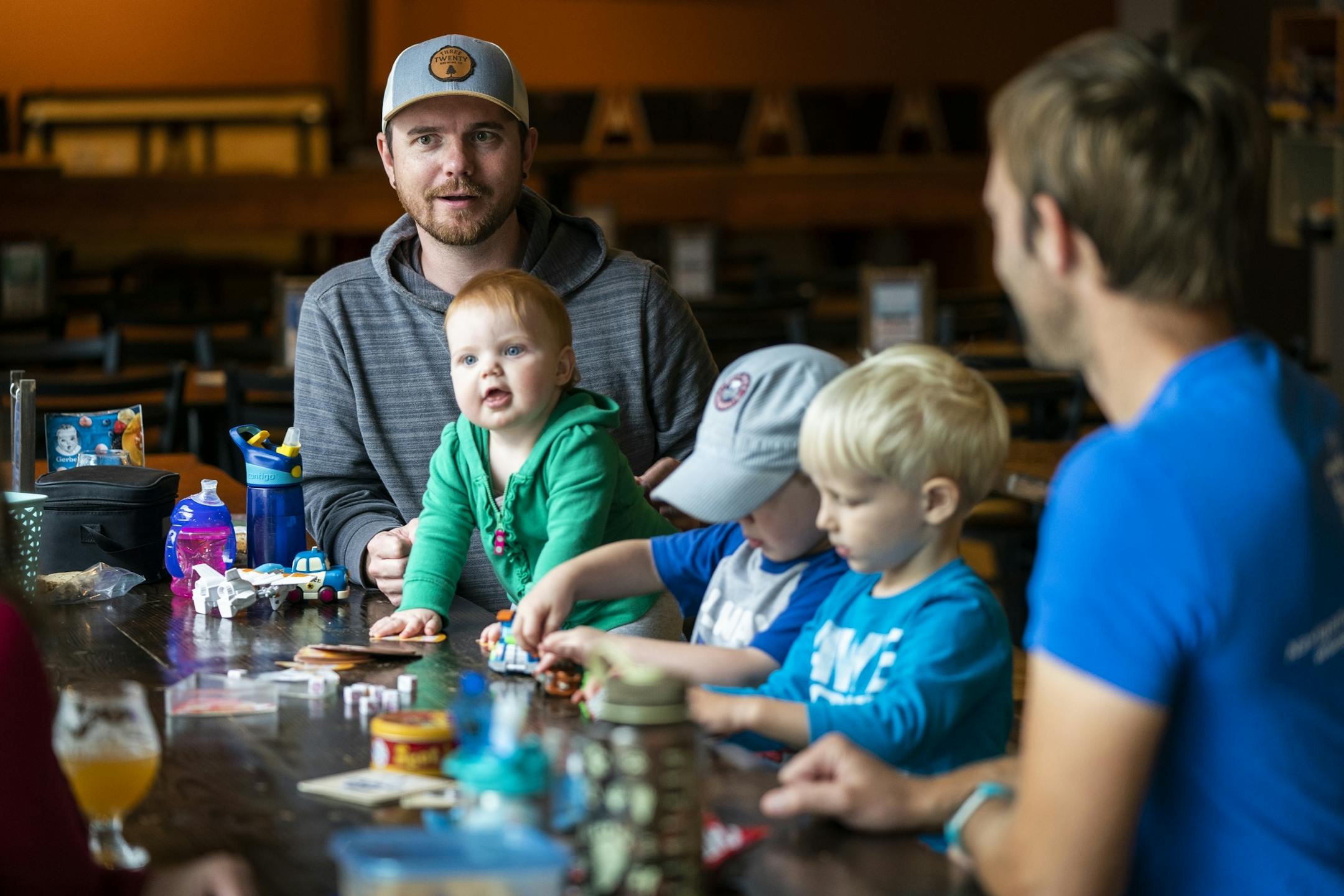 Nic Sabatke, from left, with his daughter Mae, 1, and son Anders, 3, attends a Twin Cities Dads playgroup at Omni Brewing in Maple Grove with Keith Nagel and his son Sawyer, 3.