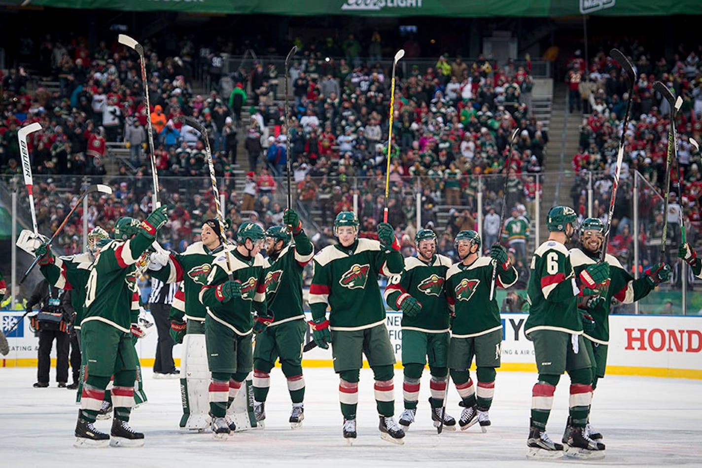 The Wild raised their sticks for the crowd after their 6-1 victory over the Chicago Blackhawks on Sunday.