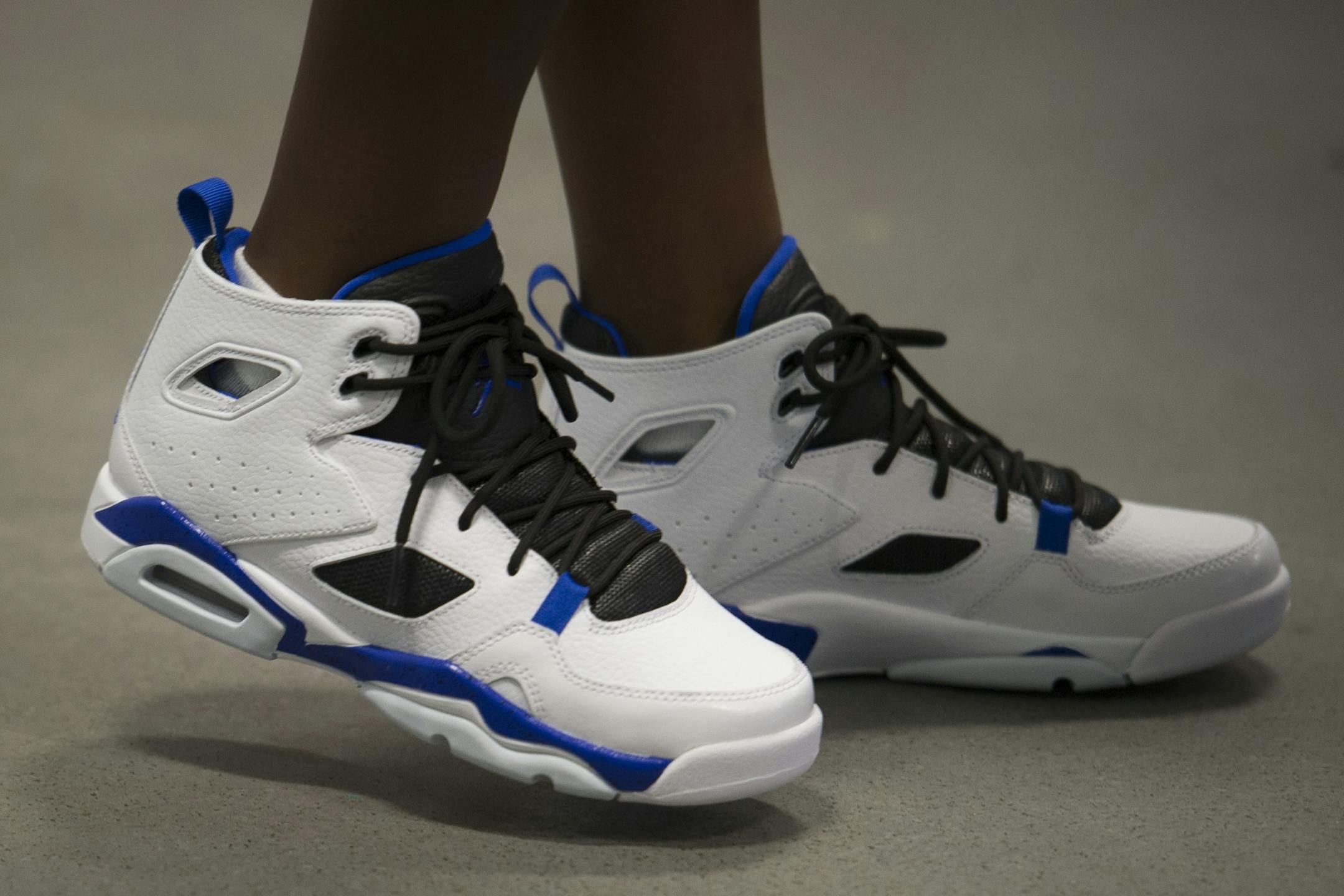 A student tries out his new Nike Jordan's shoes after they were placed on his feet by a member of the WNBA Champion Minnesota Lynx at Payne Elementary School in Washington, Wednesday, June 6, 2018. Payne Elementary has the highest homeless student population in the district.