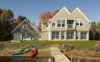 The lakeside of a new home near Lindstrom, Minn., is shaped by twin gables and combines elements of Shingle Style and Scandinavian-influenced architec