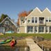 The lakeside of a new home near Lindstrom, Minn., is shaped by twin gables and combines elements of Shingle Style and Scandinavian-influenced architec