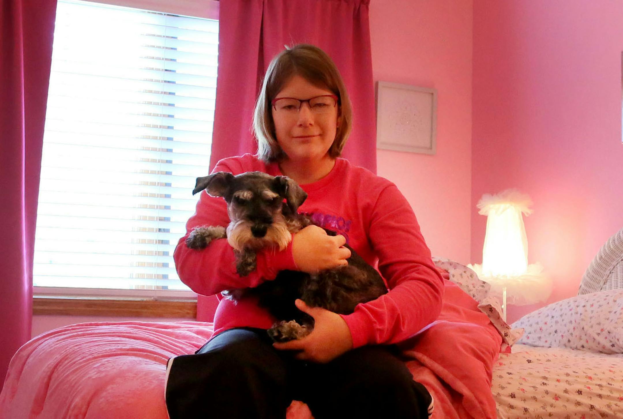 Abigail Pearson just wants a place of her own. Her parents fear theyíll die before getting an answer on a waiver for independent living. Pearson, 26, who has had a cognitive impairment since birth says she loves her parents and she loves her life. ìThe one thing missing is my independence,î she says. Here, Abby sits on her bed with her dog Lena in her pink room that has changed little since she was a young girl.](DAVID JOLES/STARTRIBUNE)djoles@startribune.com Across Minnesota, thousands of disab