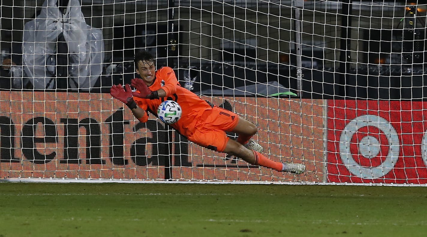 Minnesota United goalkeeper Tyler Miller (1) makes the game winning save on a penalty kick against the Columbus Crew during the second half of an MLS soccer match in Kissimmee, Fla., Tuesday, July 28, 2020. (AP Photo/Reinhold Matay)