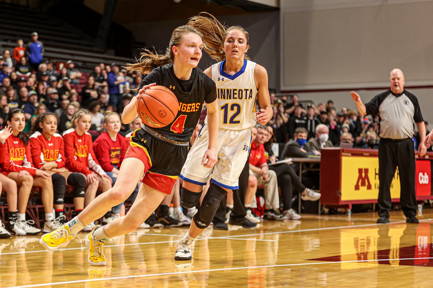 Mountain Iron-Buhl sophomore Jordan Zubich (4) drives past Minneota's Natalee Rolbiecki in the second half. Minneota players celebrate their overtime victory over Mountain Iron-Buhl in a Class 1A quarterfinal. 2022 Girls Basketball State tournament, Class 1A quarterfinals, 3-17-22. Photo by Mark Hvidsten, SportsEngine