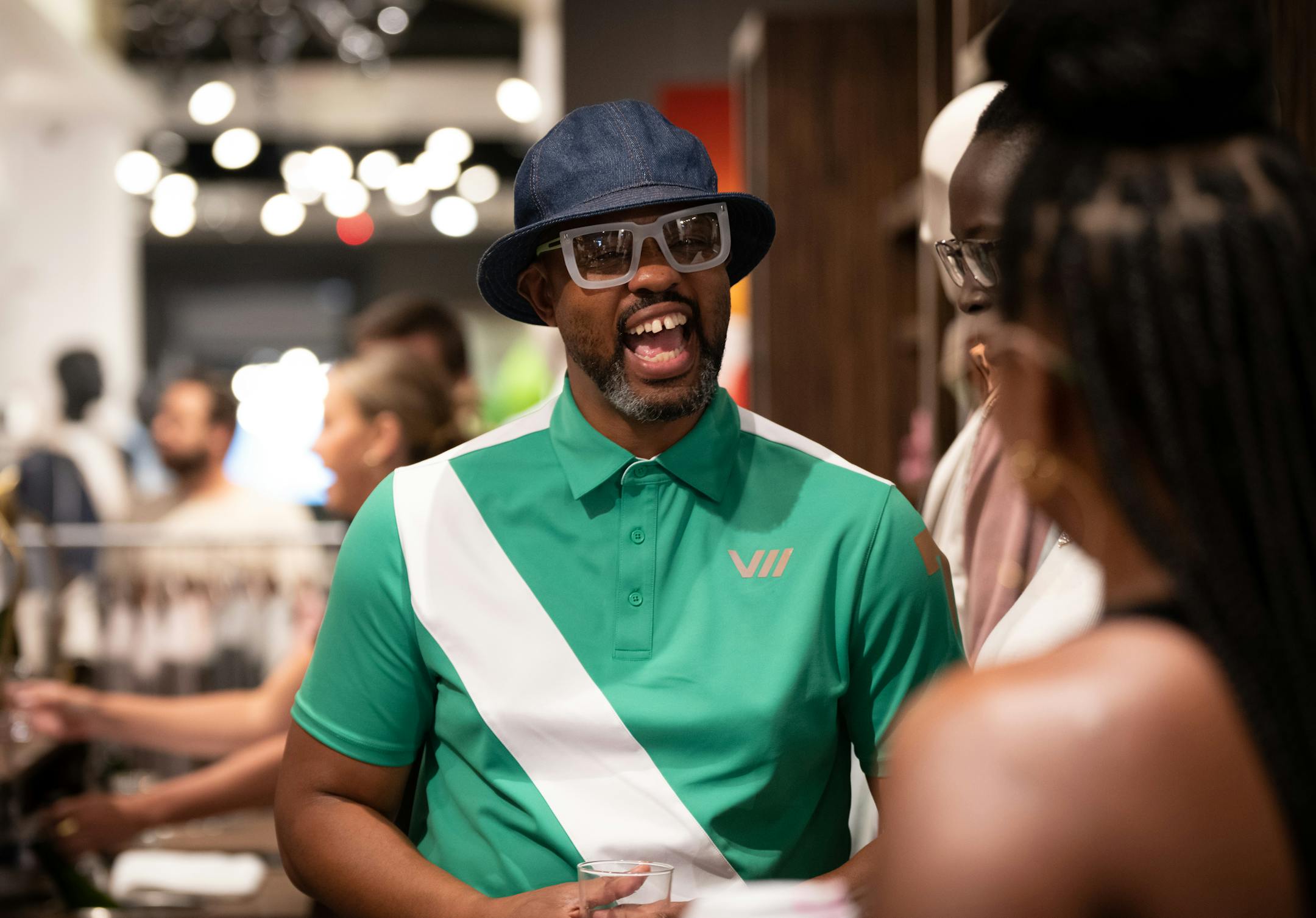 Houston White talks to guests at a pop up event at Martin Patrick 3 for White's high-end Viictory sportswear collection in June in Minneapolis.