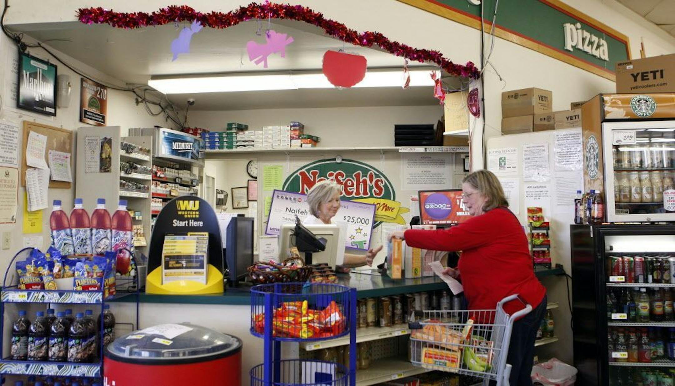 A shopper checks out at the register where lottery tickets are sold in Naifeh's Grocery in Munford, Tenn., Thursday, Jan. 14, 2016. One of the winning Powerball tickets in Wednesday's record jackpot drawing of $1.6 billion was sold at the store.