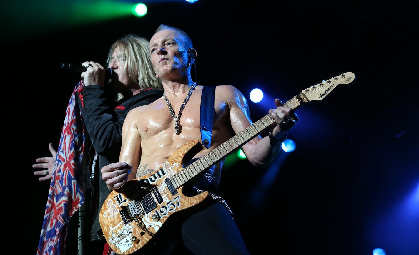 Def Leppard's Joe Elliott , left, and Phil Collen performed "Disintegrate" with the rest of the band. ] (KYNDELL HARKNESS/STAR TRIBUNE) kyndell.harkness@startribune.com Def Leppard at the Minnesota State Fair Grandstand in Andover , Min., Thursday August 27, 2015.