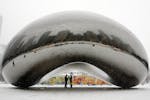 In this Jan. 31, 2008, photo a couple is seen on the underside of the 110-ton stainless steel Anish Kapoor sculpture called "Cloud Gate" and nicknamed
