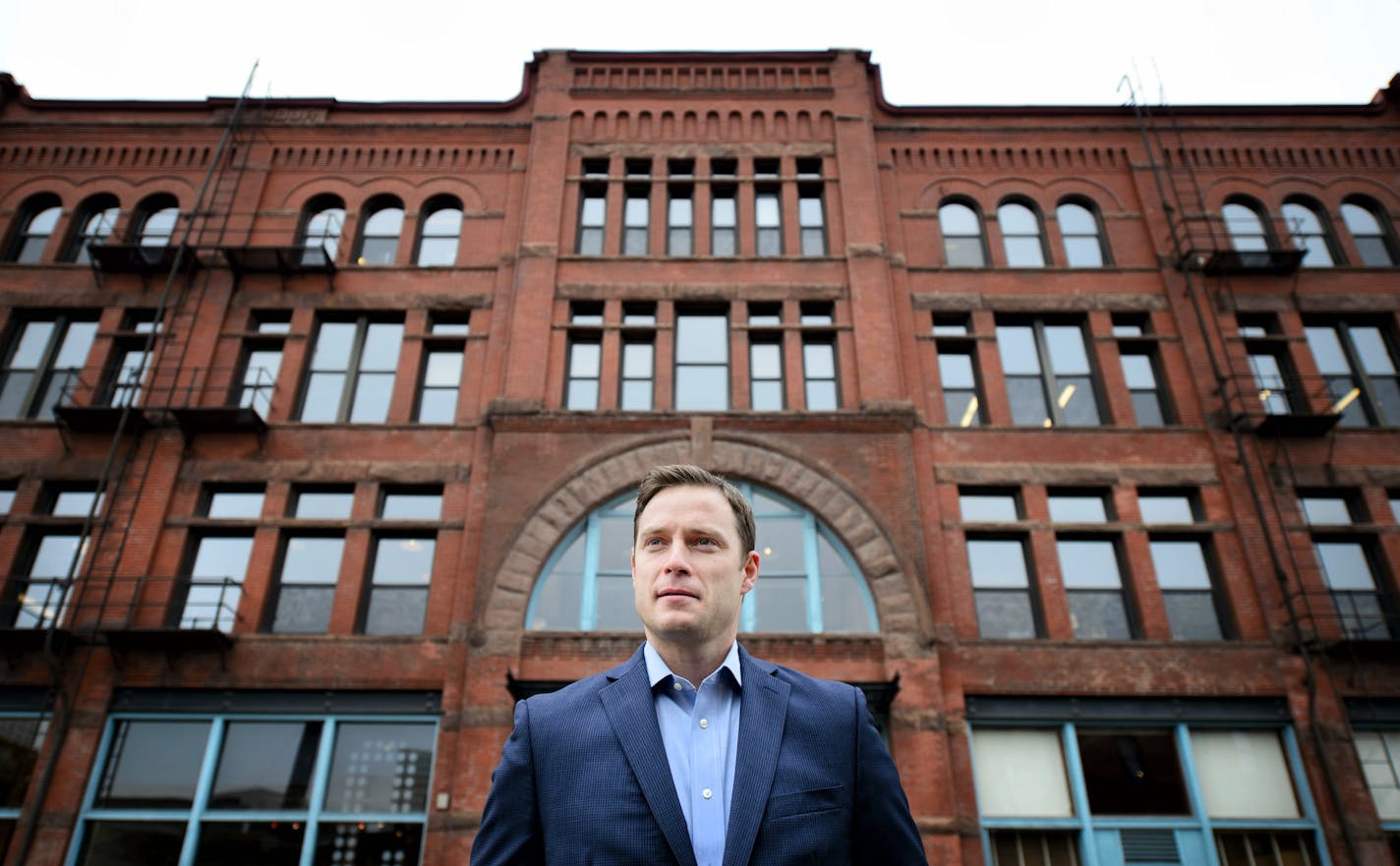 Evan Richardson with the real estate development firm Schafer Richardson. Evan is in charge of the firm's real estate investment trust. The building behind him at the corner of 1st St N and 2nd Ave N is one of the buildings they own. ] GLEN STUBBE * gstubbe@startribune.com Tuesday October 27, 2015