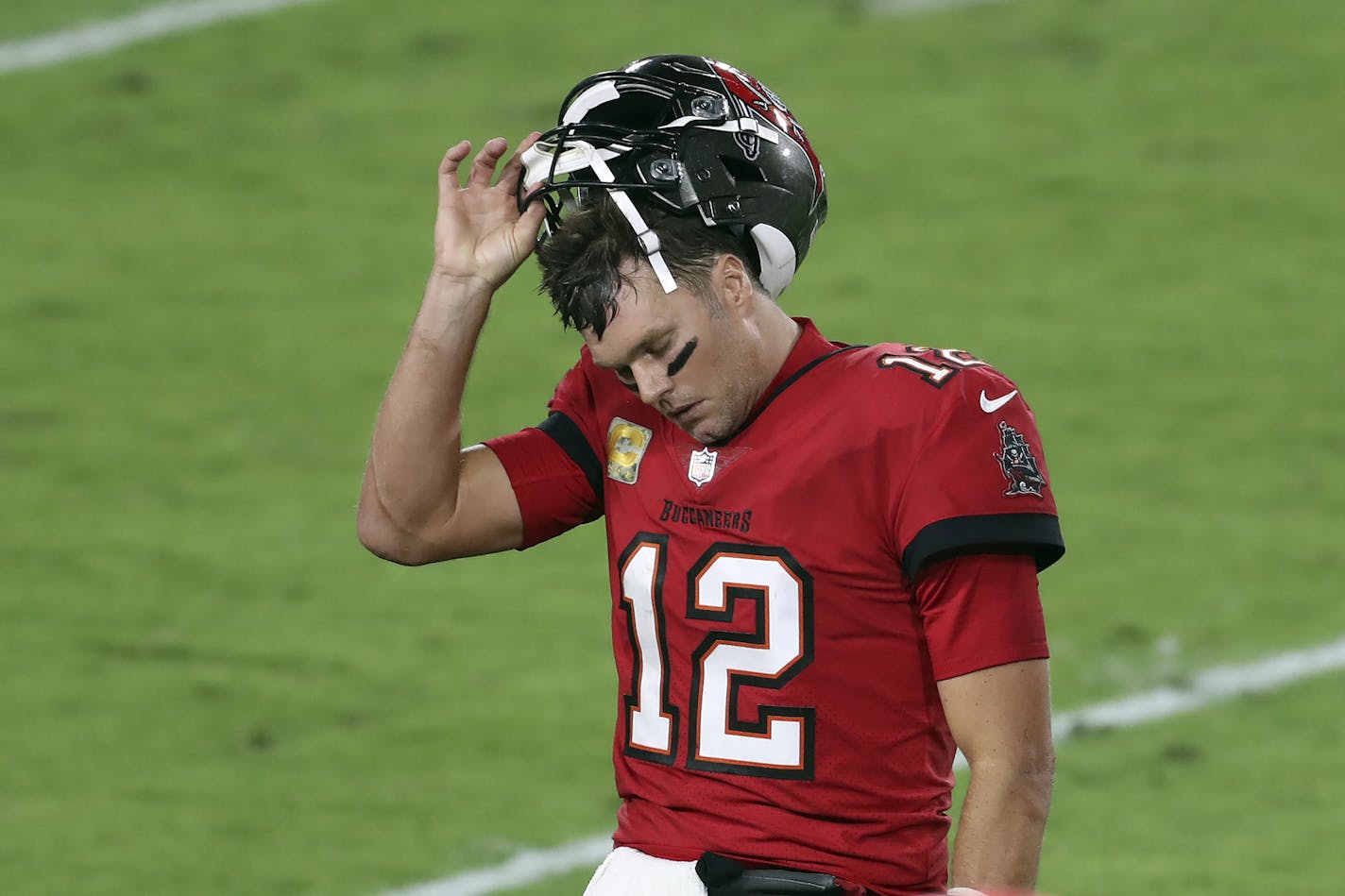 Tampa Bay Buccaneers quarterback Tom Brady (12) reacts as he leaves the field after throwing an interception against the New Orleans Saints during the second half of an NFL football game Sunday, Nov. 8, 2020, in Tampa, Fla. (AP Photo/Mark LoMoglio)