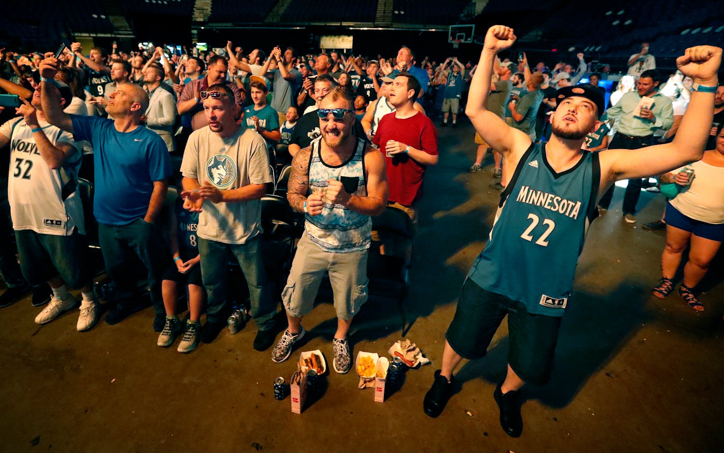 Joshua Hill, 34, (right) of Minneapolis celebrated after the Timberwolves selected Kris Dunn with 5th pick of the draft.