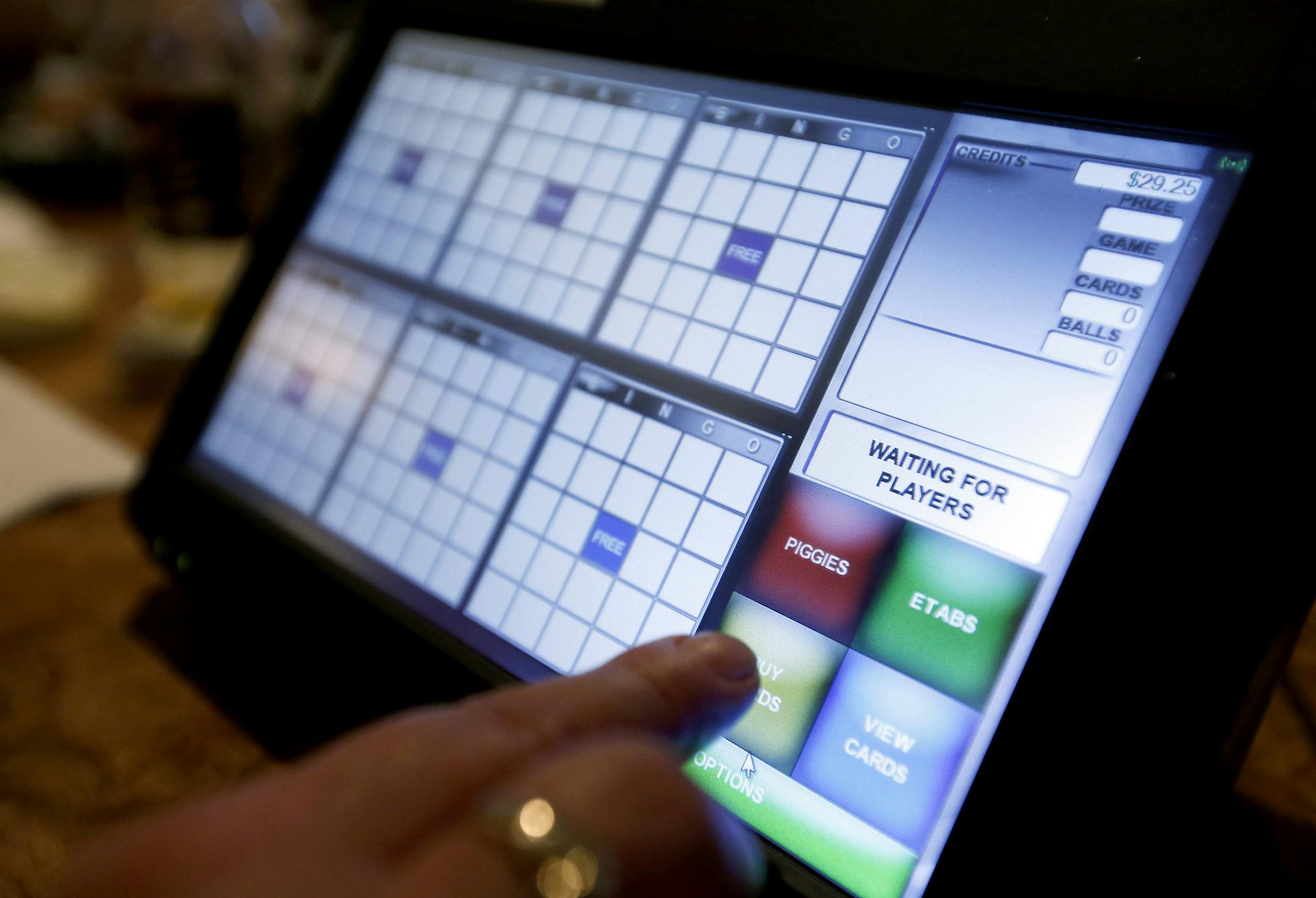 Rona Nesser, of Blaine played electronic bingo at the Blainebrook Entertainment Center in Blaine on Thursday. ] CARLOS GONZALEZ cgonzalez@startribune.com March 27, 2013, Blaine, Minn., The Blainebrook Entertainment Center is one of the two or three test sites for the new electronic linked bingo games. Electronic linked bingo, the second leg of Minnesota's plan to fund the Minnesota Vikings stadium, is expected to begin rolling out at bars and restaurants this week.
