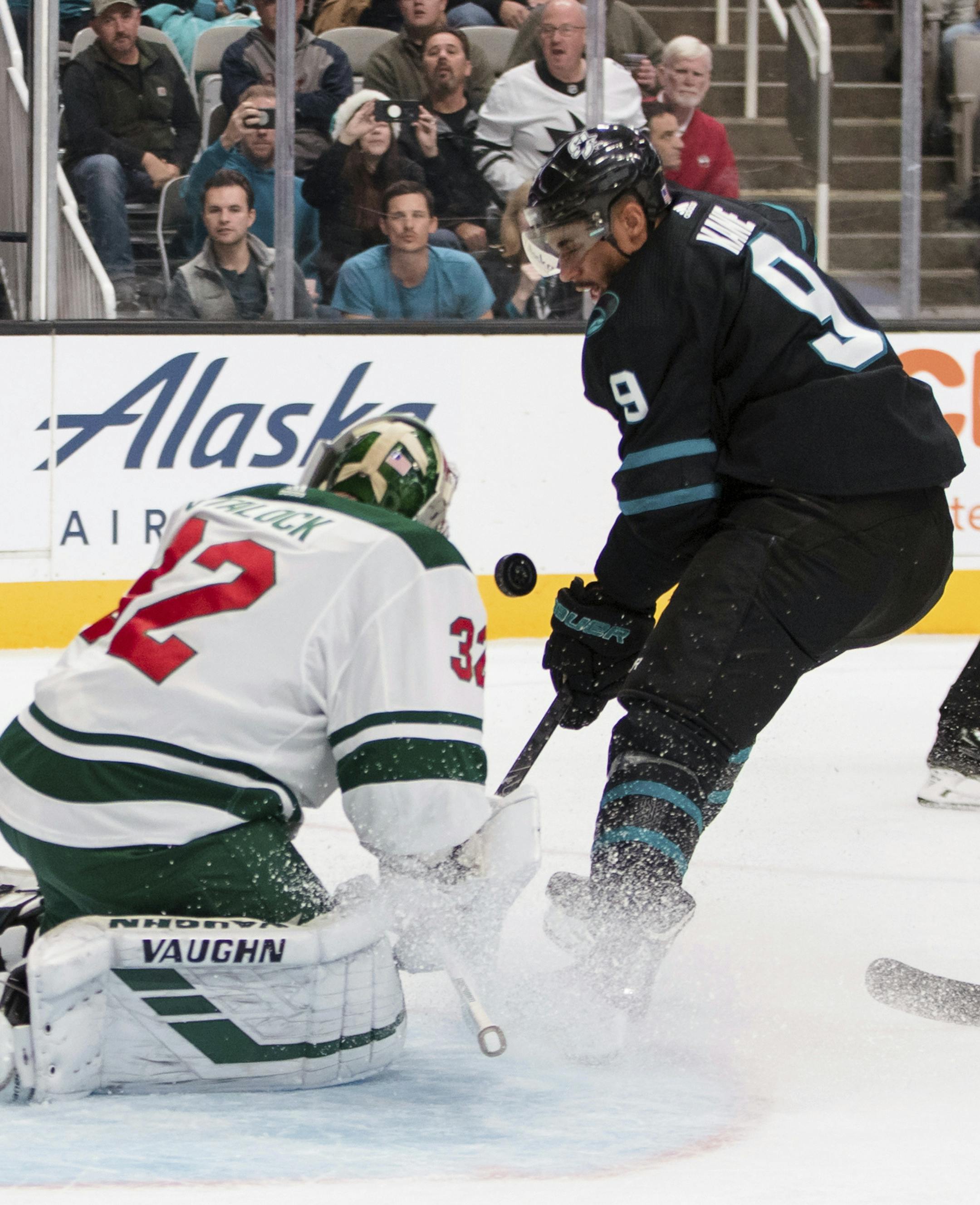Minnesota Wild goaltender Alex Stalock (32) deflects a shot by San Jose Sharks' Evander Kane (9) during the first period of an NHL hockey game Thursday, Nov. 7, 2019, in San Jose, Calif. (AP Photo/John Hefti)