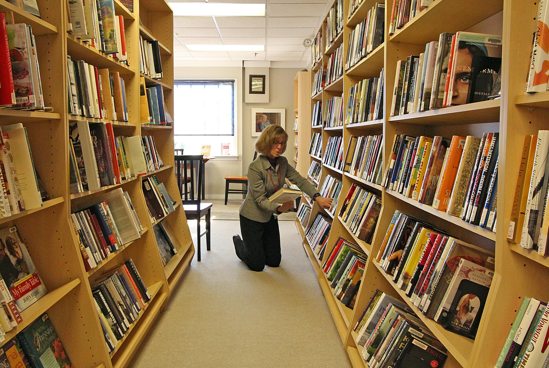 Library volunteer Sue Logan works to attract more patrons by regularly updating the collection with new books. She said library attendance is up 15 percent from last year.