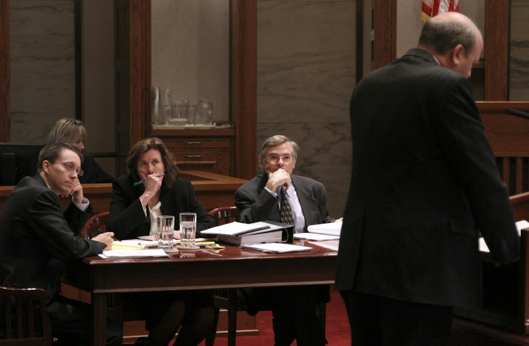 Lawyers for the Emmer campaign listen to Mark Dayton's lawyer, Marc Elias, challenge their argument before the state Supreme Court Monday afternoon.