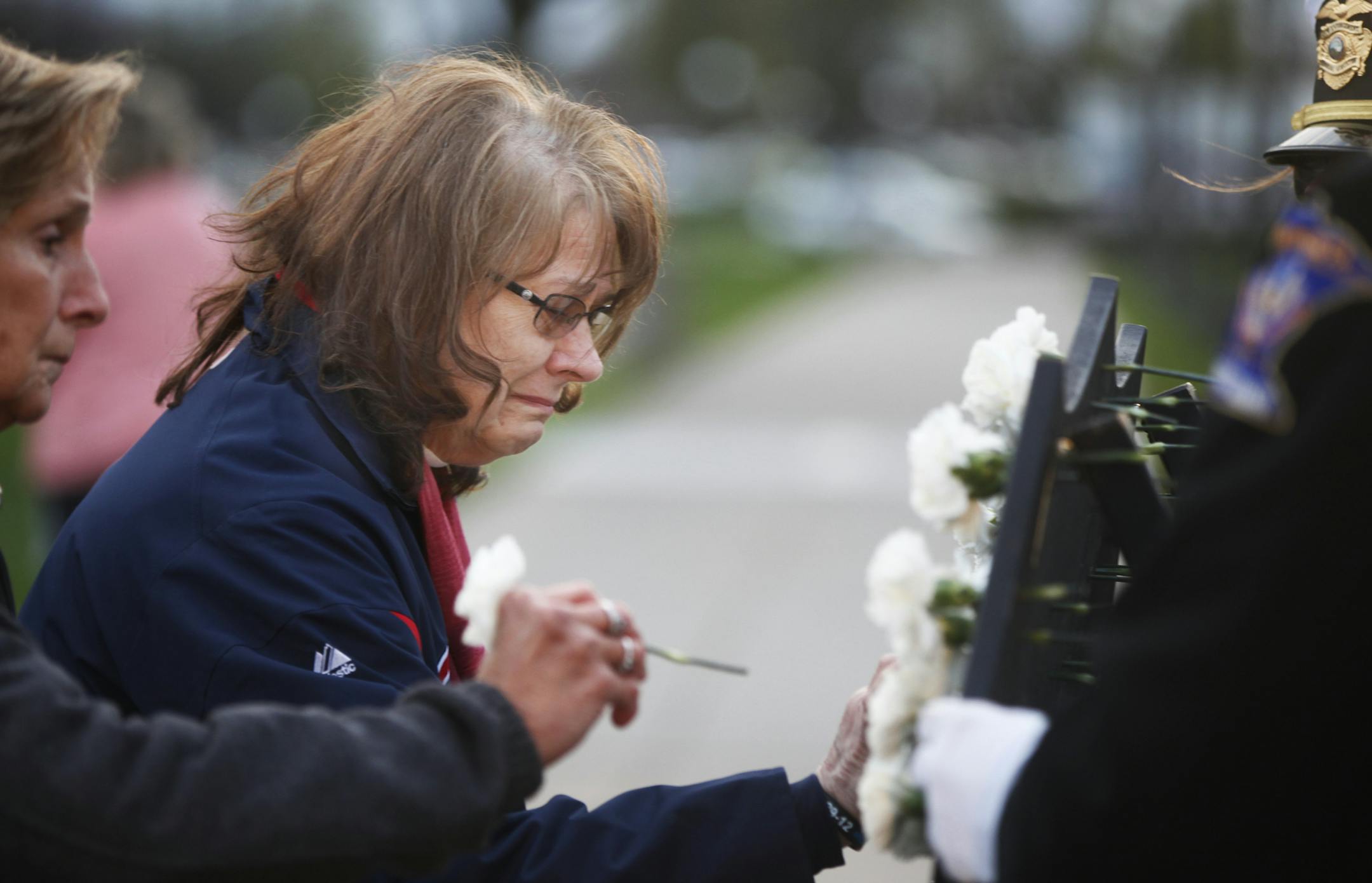 On May 15, 2014,at the Peace Officers Memorial on the State Capitol Grounds, police officers from around the state and family members paid tribute to fallen Minnesota peace officers. Rosella Decker placed a carnation on an honor shield for her son, police officer Tom Decker of Cold Springs, who died in an ambush in 2012. "You just can't get over that," she said of losing her son.]richard.tsong-taatarii/rtsong-taatarii@startribune.com