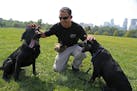 ATF agent Nic Garlie gave some love to his dogs Brock (left) and Taylor at the end of a training session.