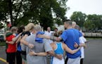 Before and after every run, members of the Mile In My Shoes running group huddle up to encourage each other. The group, pictured here on a 2018 run, c