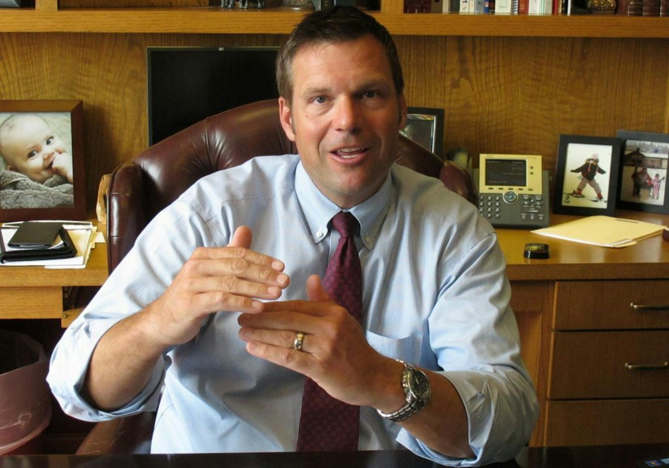 In this Aug. 1, 2013, photo, Kansas Secretary of State Kris Kobach answers questions during an interview in his office in Topeka, Kan.