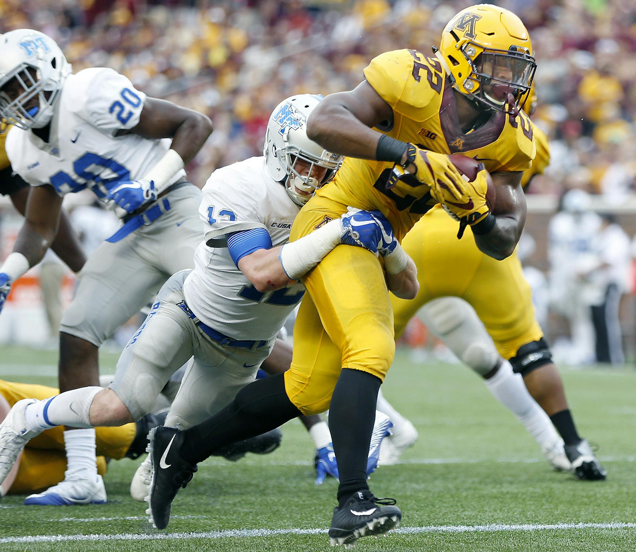 Minnesota's running back Kobe McCrary plowed into the end zone taking Middle Tennessee's defensive back Reed Blankenship with him for a touchdown during the fourth quarter as the Gophers took on Middle Tennessee at TCF Bank Stadium, Saturday, September 16, 2017 in Minneapolis, MN. ] ELIZABETH FLORES ï liz.flores@startribune.com ORG XMIT: MIN1709161855030197