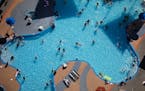 People swim on the Fourth of July in a pool at the Strat hotel-casino Saturday, July 4, 2020, in Las Vegas. (AP Photo/John Locher)