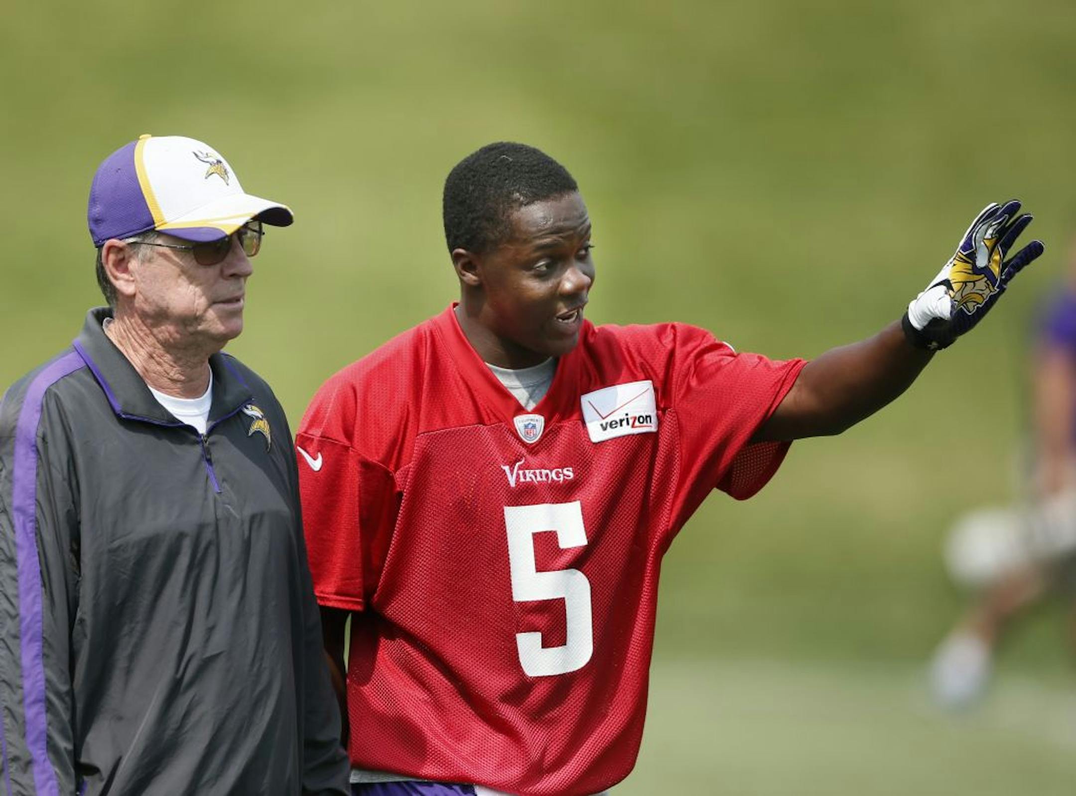 Vikings offensive coordinator Norv Turner left talked with rookie quarter back Teddy Bridgewater during OTA practice at Winter Park 2014 in Eden Prairie,MN.