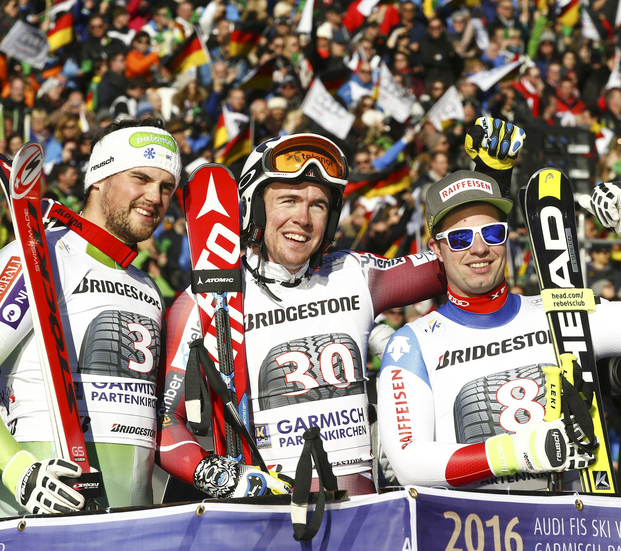 Norway's Aleksander Aamodt Kild, center, winner of an alpine ski, men's World Cup downhill, celebrates with second placed Slovenia's Bostjan Kline, left, and third placed Switzerland's Beat Feuz, in Garmisch-Partenkirchen, Germany, Saturday, Jan. 30, 2016. (AP Photo/Giovanni Auletta)