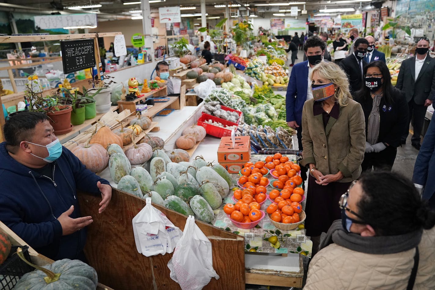 Former Second Lady Jill Biden was flanked by members of her Secret Service detail as she talked with Leng Xiong at his produce stall while touring the Hmong Village Shopping Mall during a campaign stop for her husband democratic presidential nominee Joe Biden Thursday in St. Paul. ] ANTHONY SOUFFLE • anthony.souffle@startribune.com Fromer Second Lady Jill Biden toured the Hmong Village Shopping mall during a campaign stop on behalf of her husband democratic presidential nominee Joe Biden Thursda