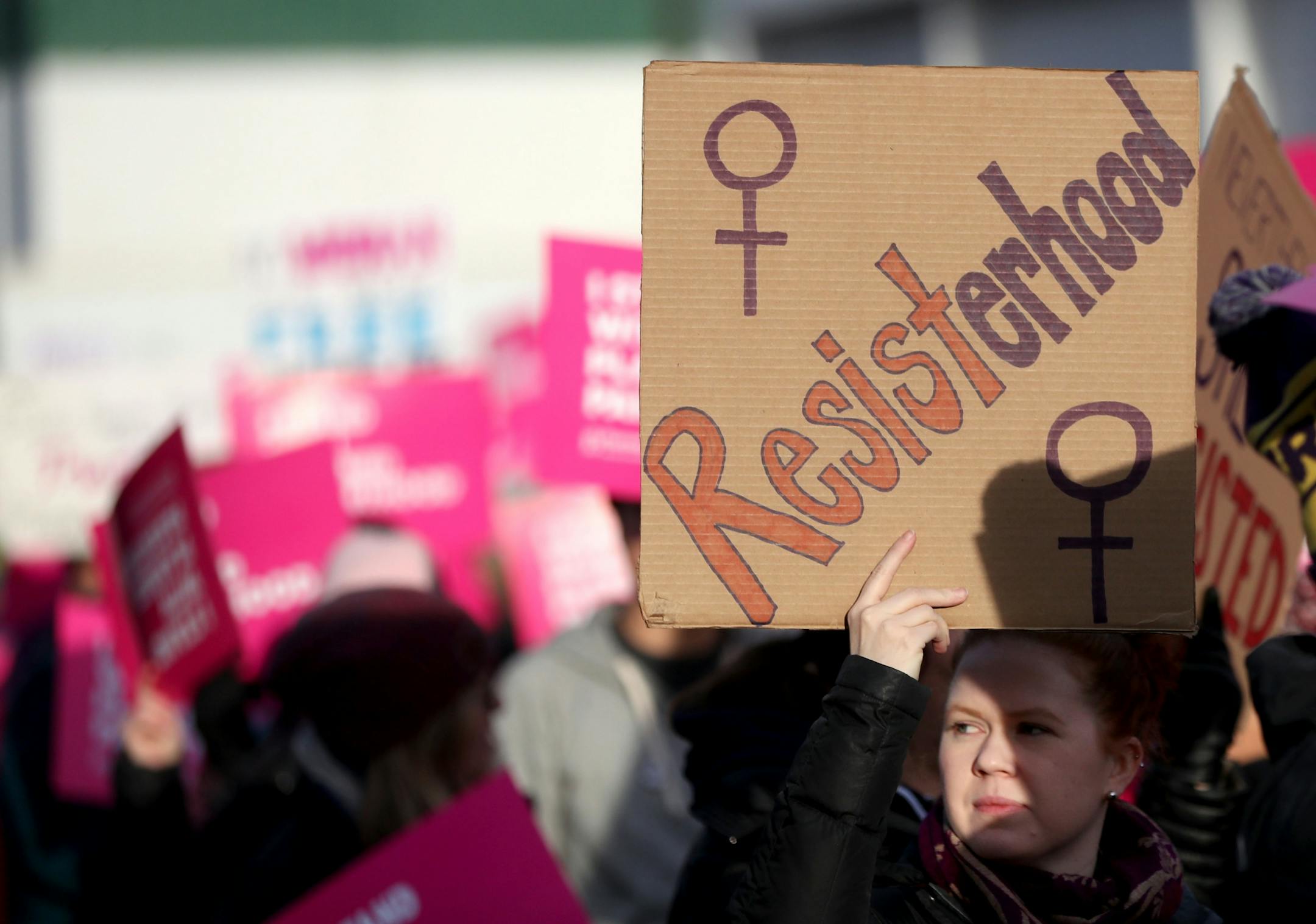 A supporter of Defend Planned Parenthood marched with a sign.