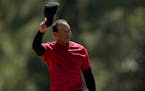 Tiger Woods tips his cap on the 18th green during the final round at the Masters golf tournament on Sunday, April 10, 2022, in Augusta, Ga. (AP Photo/