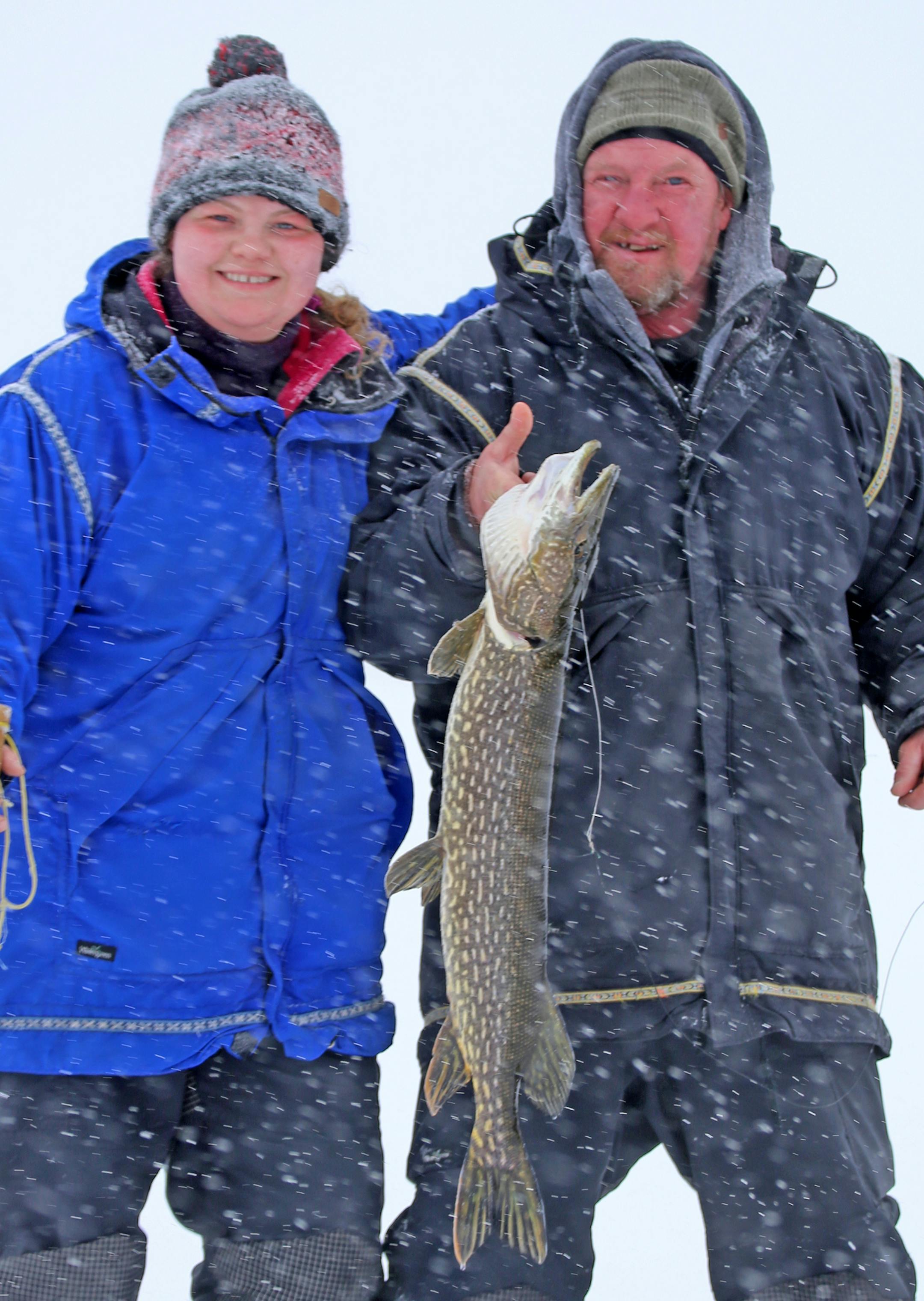 Shelby McEntyre, left, and her dad, Stu, with a northern pike caught on a dog sled trip into the Boundary Waters Canoe Area Wilderness.