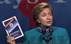 ** FILE ** Then first lady Hillary Rodham Clinton, holding a copy of the Clinton health-care plan, kicks off a three-state sales campaign during a vis