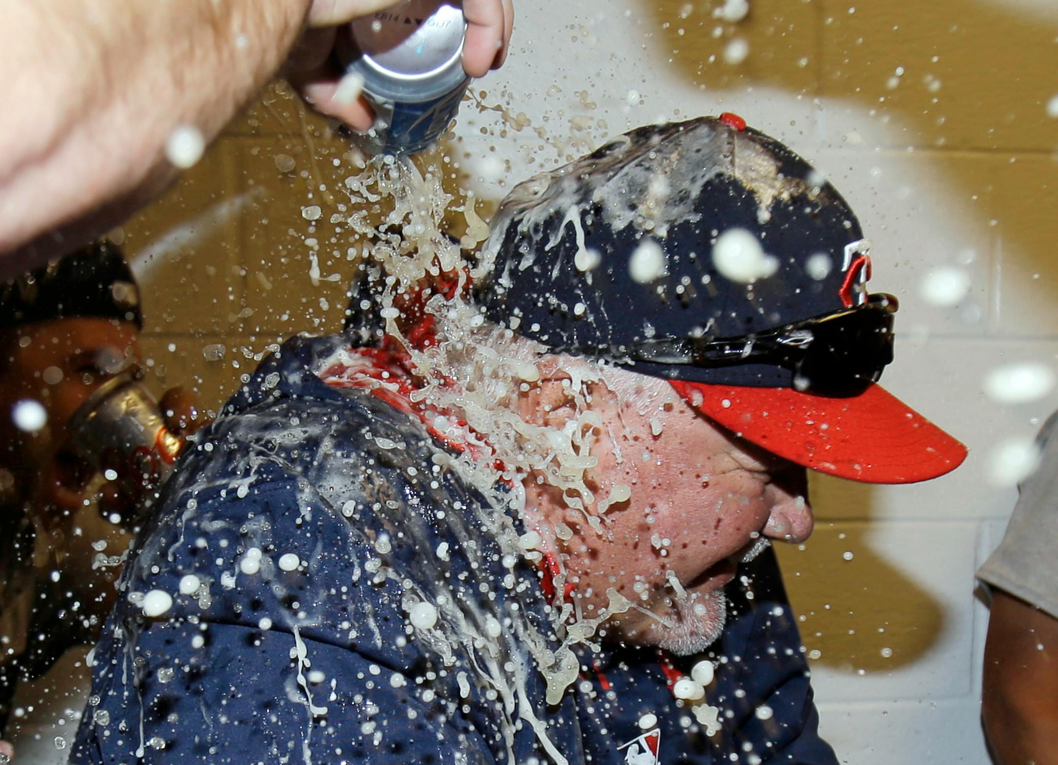 Minnesota Twins manager Ron Gardenhire is doused with beer after the Twins defeated the Cleveland Indians 7-3 in a baseball game, Saturday, April 5, 2014, in Cleveland. The Twins win gives Gardenhire his 1,000th career victory. (AP Photo/Tony Dejak
