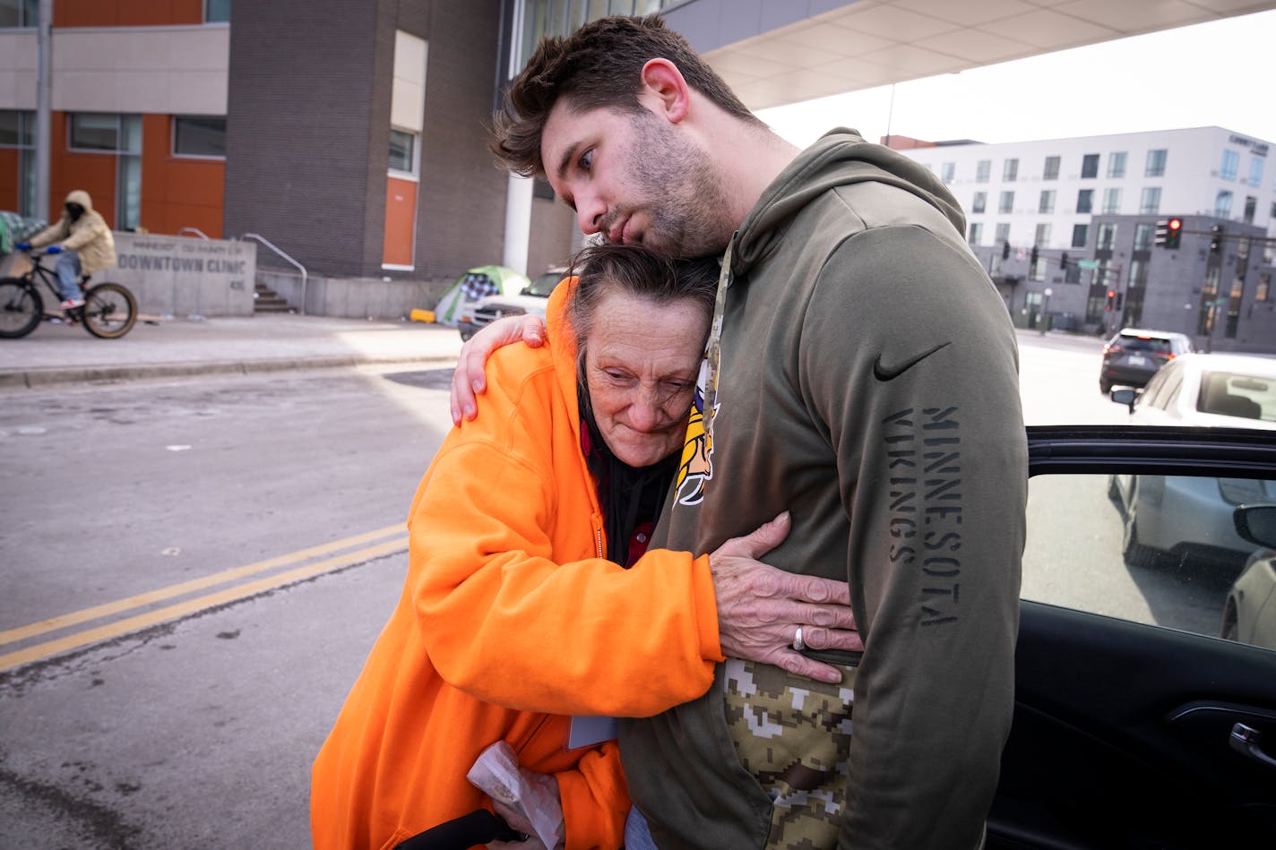 TikTok creator Josh Liljenquist gets a hug from Jamie Marazzo while he passed out egg rolls to homeless people outside Dorothy Day Center in St. Paul, Minn. Thursday, Jan. 11, 2024. Liljenquist helped out Marazzo's husband. ] LEILA NAVIDI • leila.navidi@startribune.com