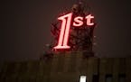 The iconic red "1st" sign in downtown St. Paul, which has been dark for 10 months, was re-lit on Tuesday, November 22, 2016, in St. Paul, Minn.