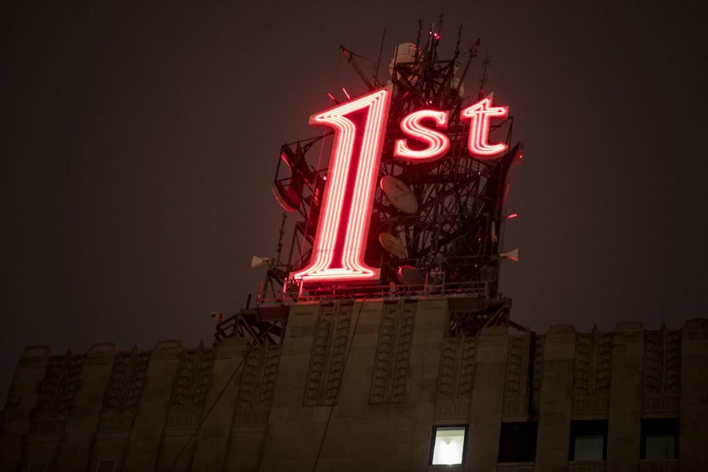 The iconic red "1st" sign in downtown St. Paul, which has been dark for 10 months, was re-lit on Tuesday, November 22, 2016, in St. Paul, Minn.