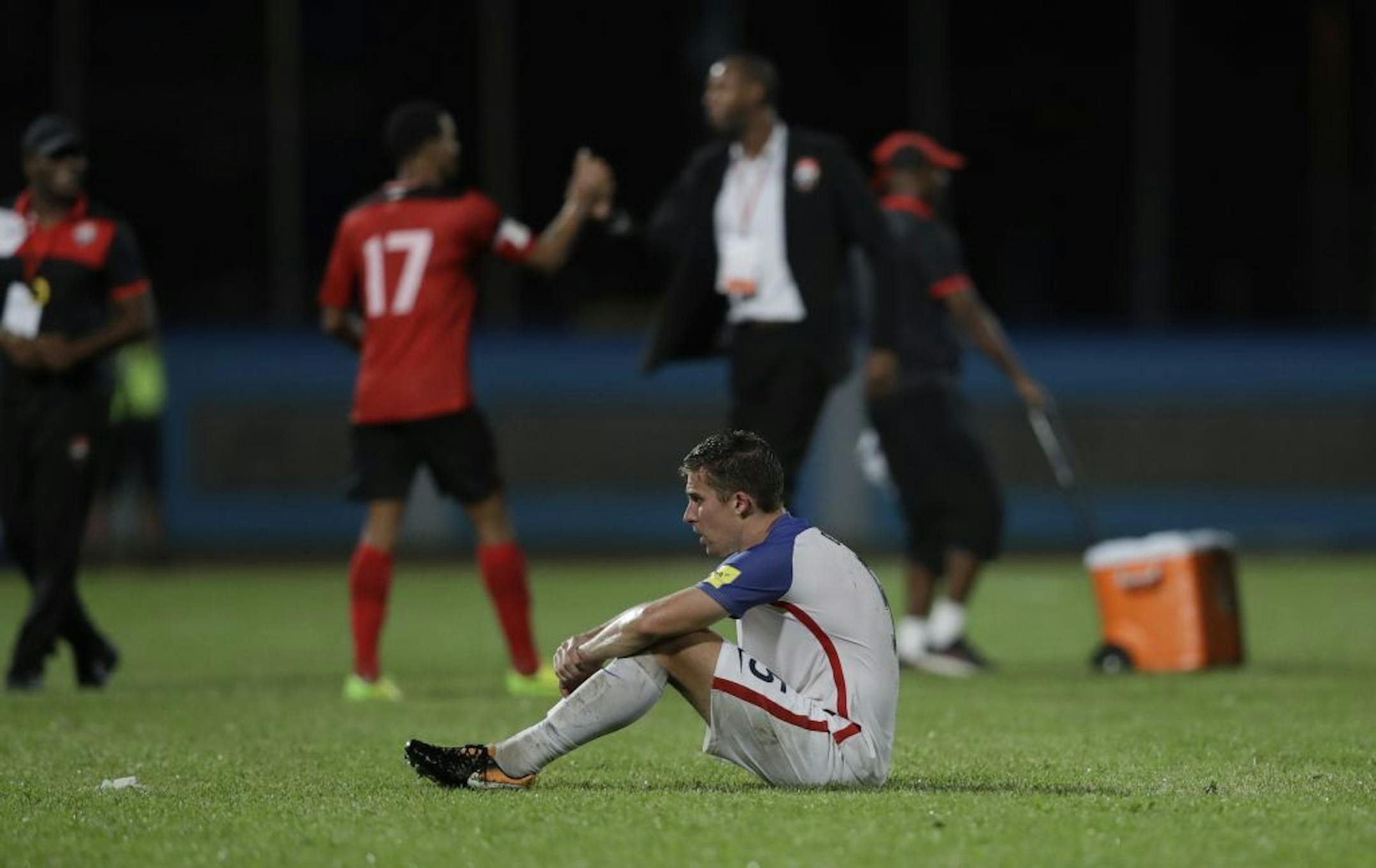 United States' Matt Besler, squats on the pitch after losing 2-1 against Trinidad and Tobago during a 2018 World Cup qualifying soccer match in Couva, Trinidad, Tuesday, Oct. 10, 2017.